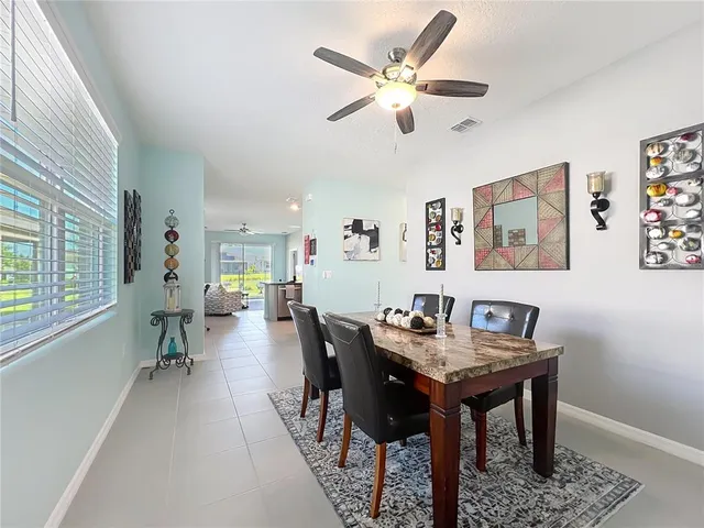 a view of a dining room with furniture and a large window