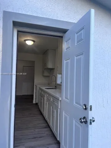 a kitchen with a sink and cabinets