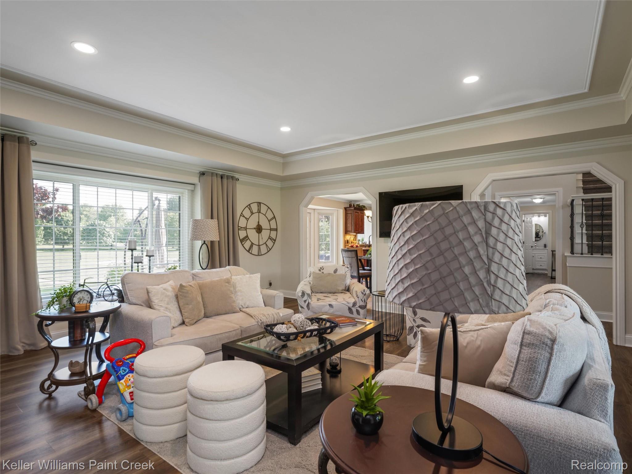 5813 36 Mile Road Romeo, MI 48065 - Photo 6 of 81 Spacious living area featuring expansive window overlooking outdoor greenery, crown molding, recessed lighting, and wood-finish flooring