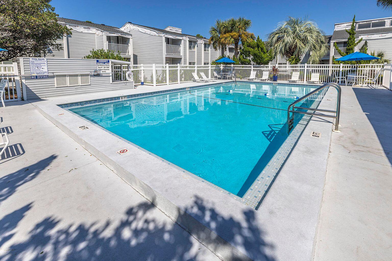 101 Old Ferry Road, Unit 5B Shalimar, FL 32579 - Photo 19 of 19 a view of a swimming pool with a lounge chairs