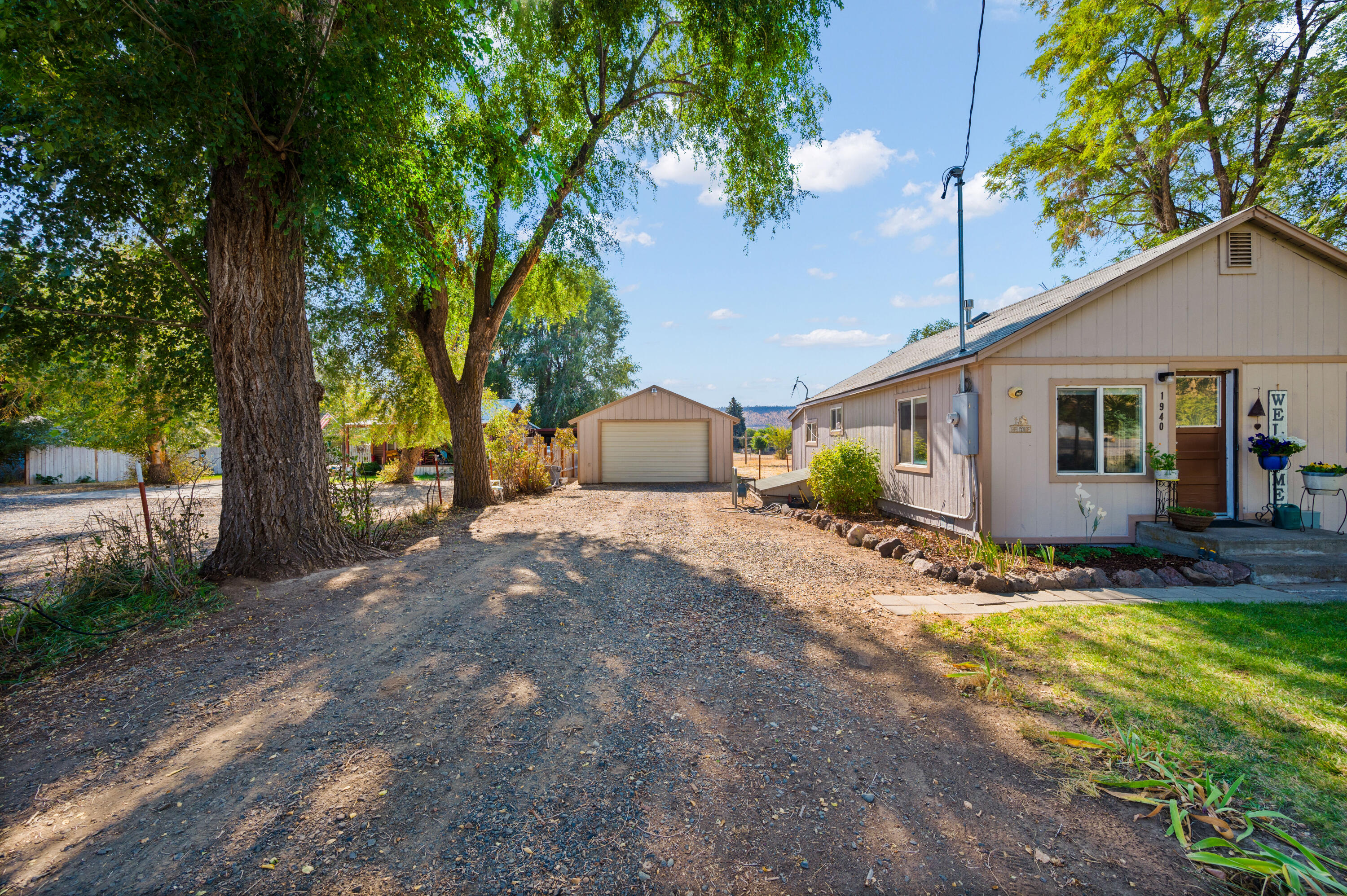 1940 Northeast Laughlin Road Prineville, OR 97754 - Photo 24 of 34 a view of a house with backyard and a tree