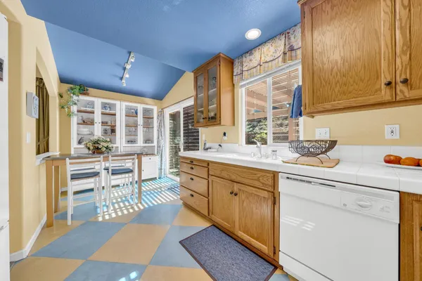 a spacious bathroom with a granite countertop sink a mirror and a bathtub
