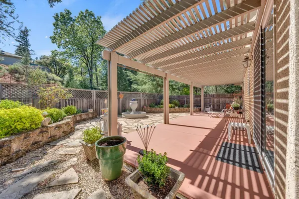 a view of a chair and table in backyard