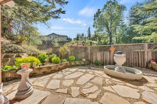 a view of a house with backyard and sitting area