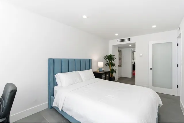 a bedroom with a bed and a chair