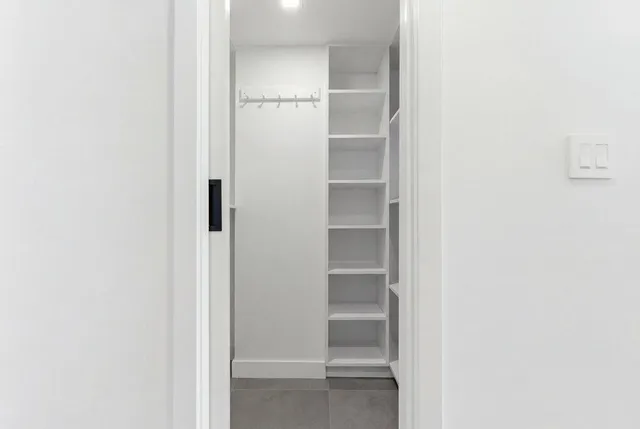 a view of walk in closet with empty racks
