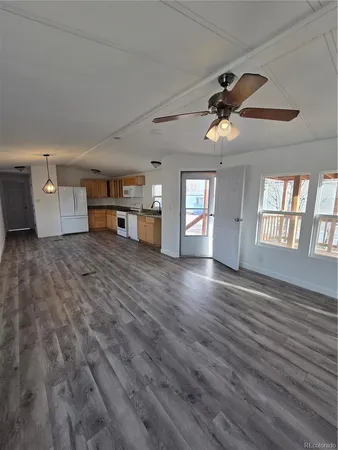 a view of a livingroom with a window and wooden floor