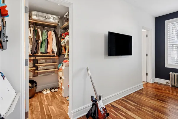 a view of a livingroom with wooden floor and a flat screen tv