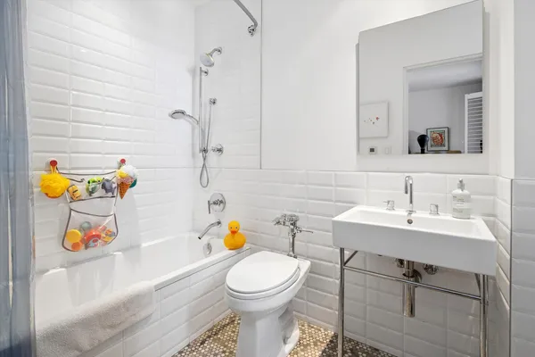 a bathroom with a sink a toilet and a shower