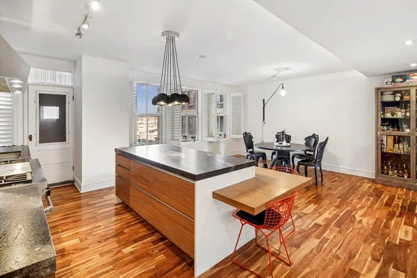 a living room with dining room and wooden floor
