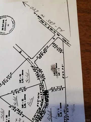 a view of a room with rack on the wall and a potted plant