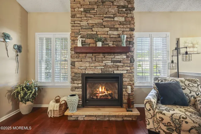 a living room with furniture a fireplace and a flat screen tv