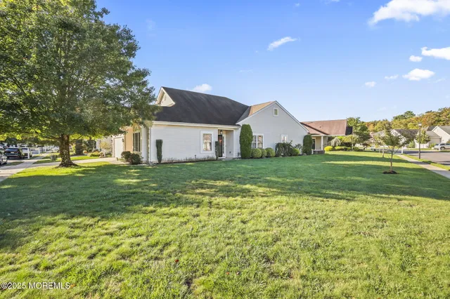 a bathroom with a granite countertop sink a toilet and a mirror