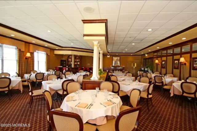 a room with pool table and windows