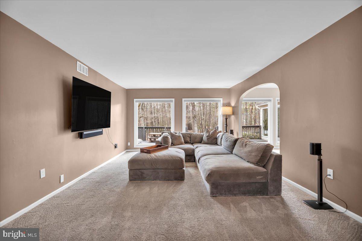 128 Bortons Road Marlton, NJ 08053 - Photo 11 of 48 a living room with furniture a flat screen tv and a large window