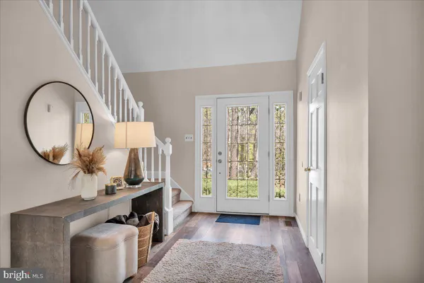 a view of an entryway with wooden floor