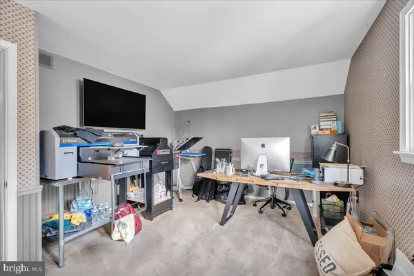 a workspace with furniture and a flat screen tv