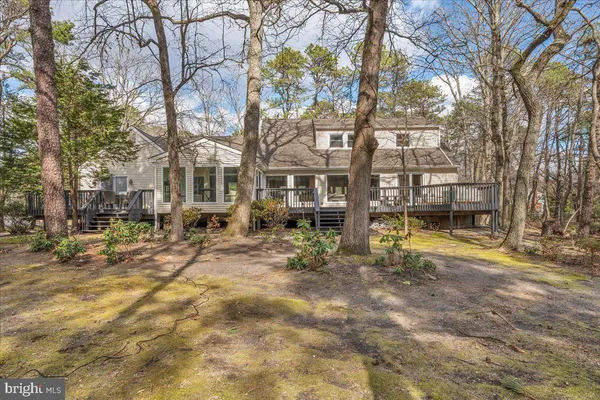 a view of a house with a yard covered in snow