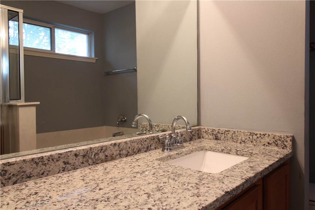 11505 Oltons Bluff Cove Austin, TX 78754 - Photo 10 of 21 a bathroom with a granite countertop sink and a mirror