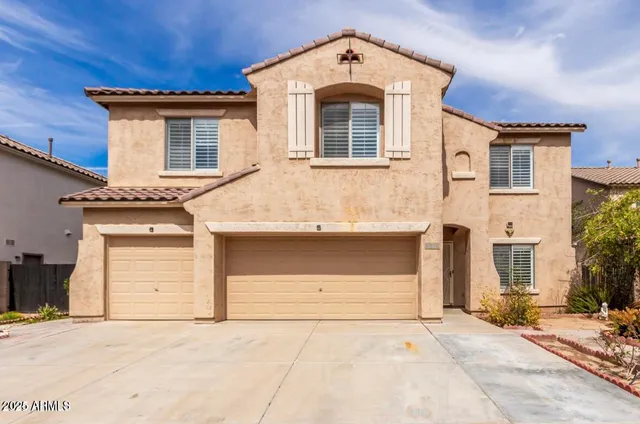 a front view of a house with a garage
