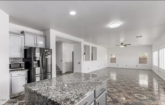 a kitchen with stainless steel appliances granite countertop a sink stove and refrigerator