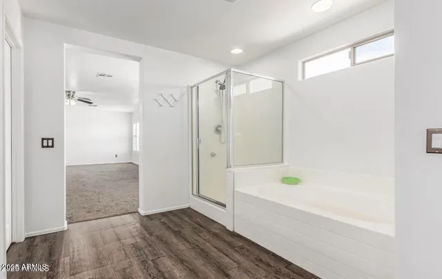 a bathroom with a tub shower and a sink