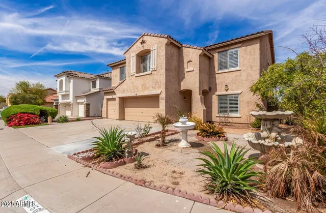 a row of palm trees in front of a house