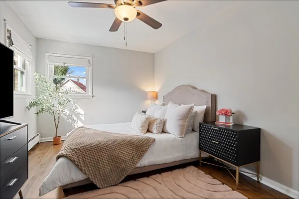 a bedroom with a bed and a chandelier