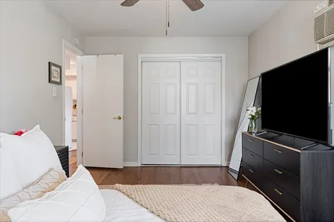 a bedroom with a bed and flat screen tv