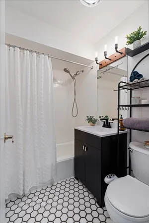 a bathroom with a sink vanity mirror and toilet