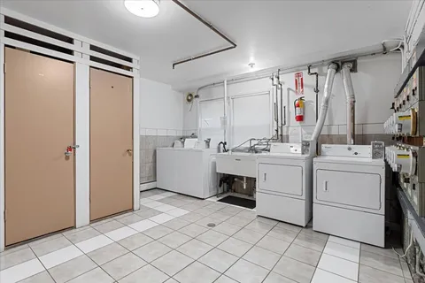 a utility room with cabinets washer and dryer