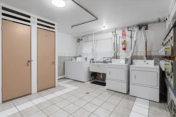 a utility room with cabinets washer and dryer