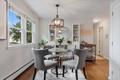a view of a dining room with furniture window and wooden floor