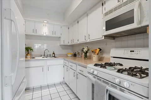 a kitchen with cabinets and appliances