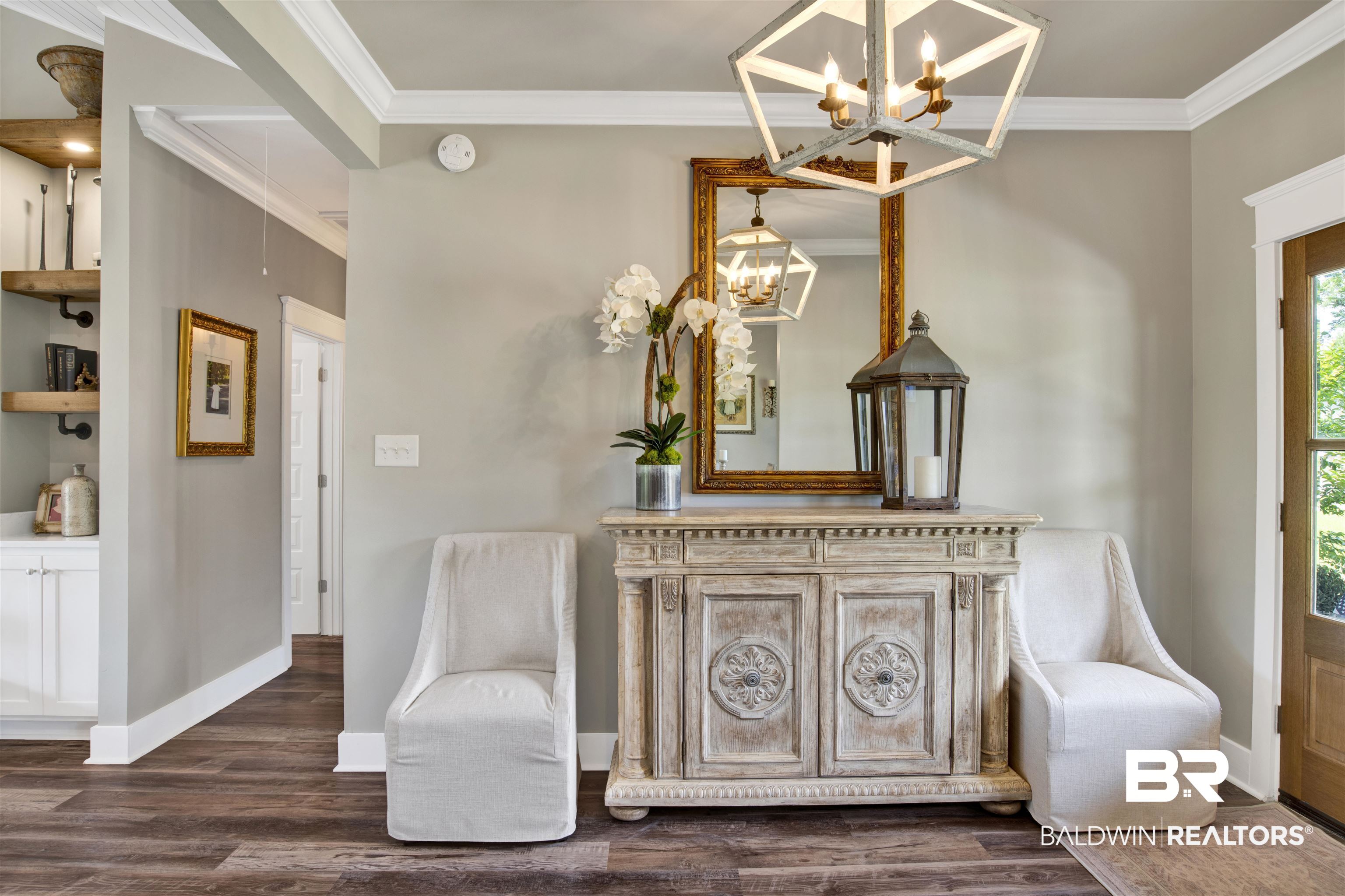 21621 Veranda Boulevard Fairhope, AL 36532 - Photo 28 of 51 Sitting room with crown molding, baseboards, dark wood-style flooring, and a notable chandelier
