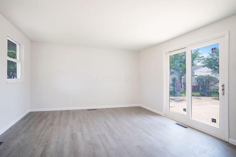 NEW flooring throughout the home! NEW sliding doors to access patio.