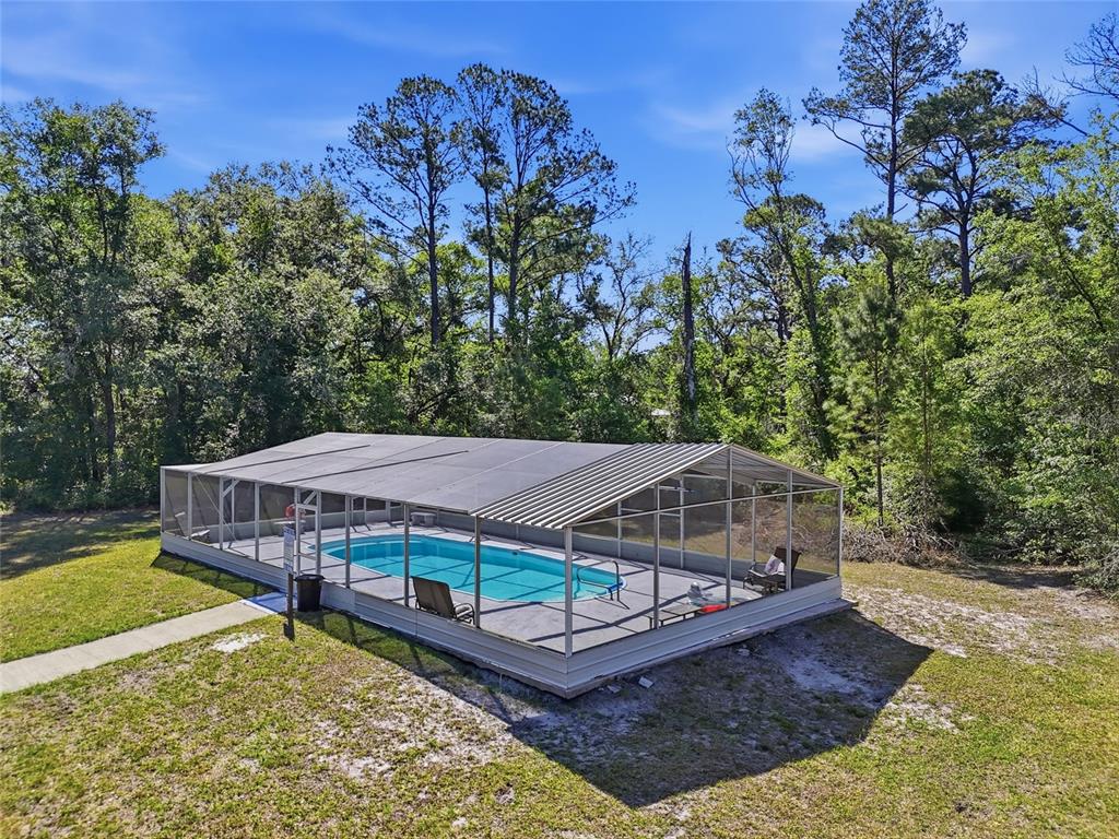 401 Southeast Falcon Road Branford, FL 32008 - Photo 21 of 76 a view of a house with pool and wooden deck
