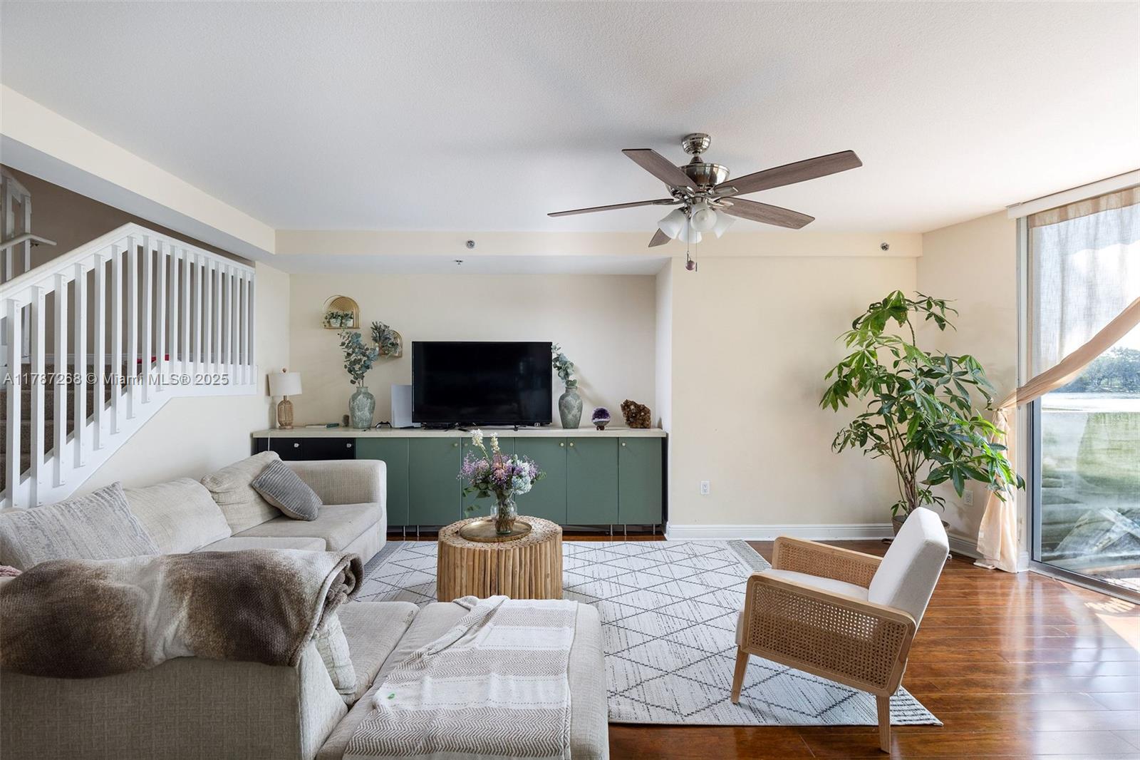 2681 North Flamingo Road, Unit TH4S Sunrise, FL 33323 - Photo 14 of 27 a living room with furniture a ceiling fan and a flat screen tv