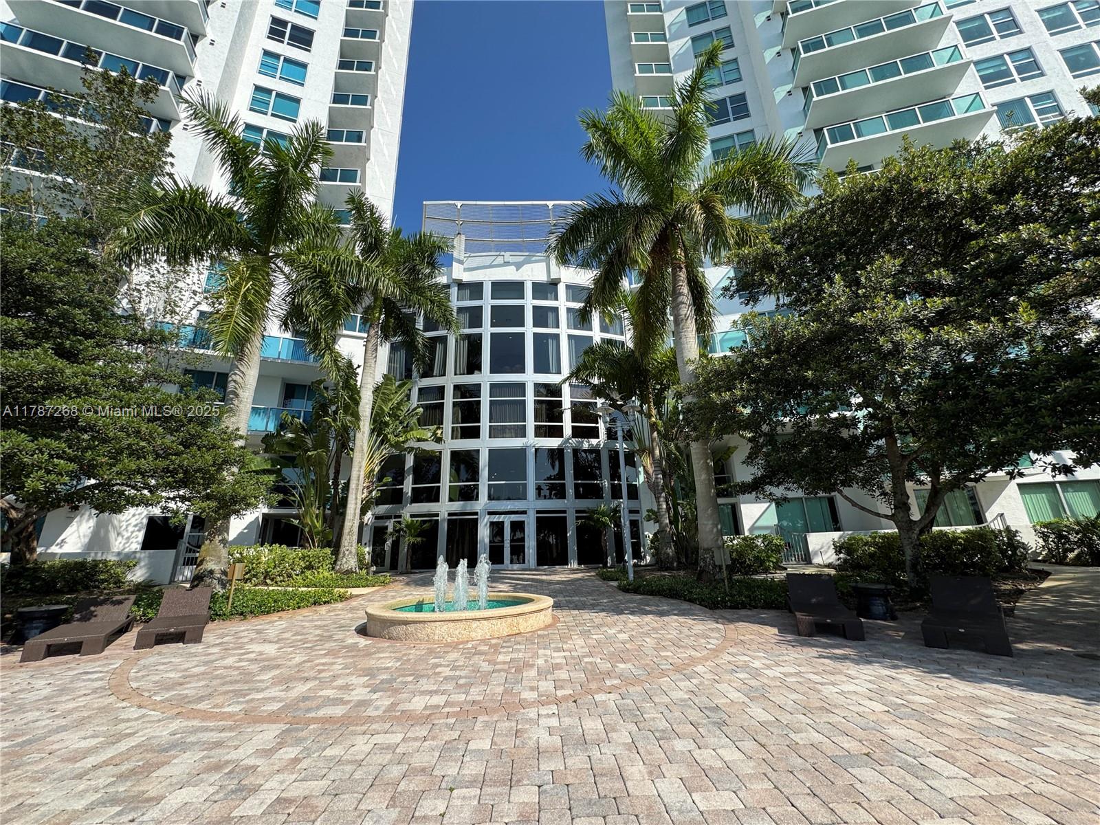 2681 North Flamingo Road, Unit TH4S Sunrise, FL 33323 - Photo 20 of 27 a view of a building with a garden