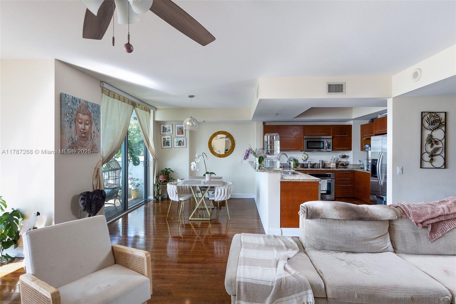 2681 North Flamingo Road, Unit TH4S Sunrise, FL 33323 - Photo 2 of 27 a living room with furniture and a wooden floor
