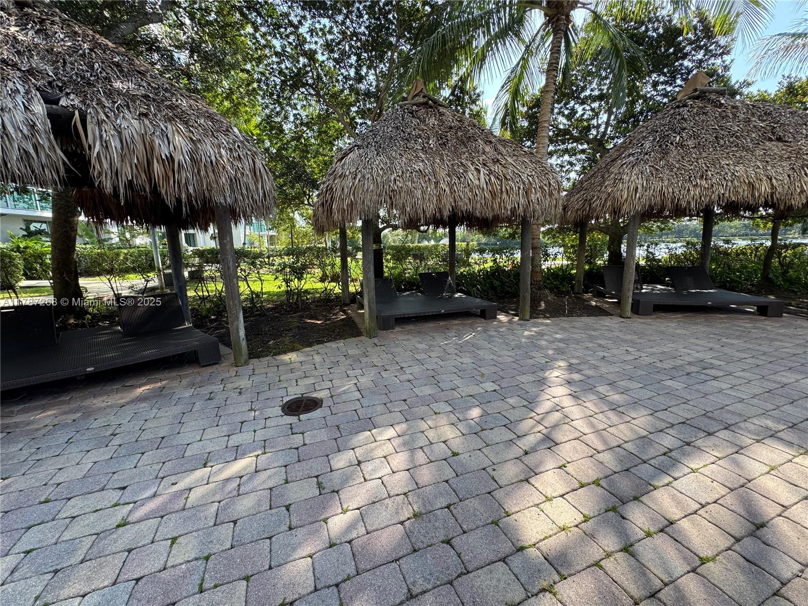 2681 North Flamingo Road, Unit TH4S Sunrise, FL 33323 - Photo 23 of 27 a view of a yard with plants and a barbeque