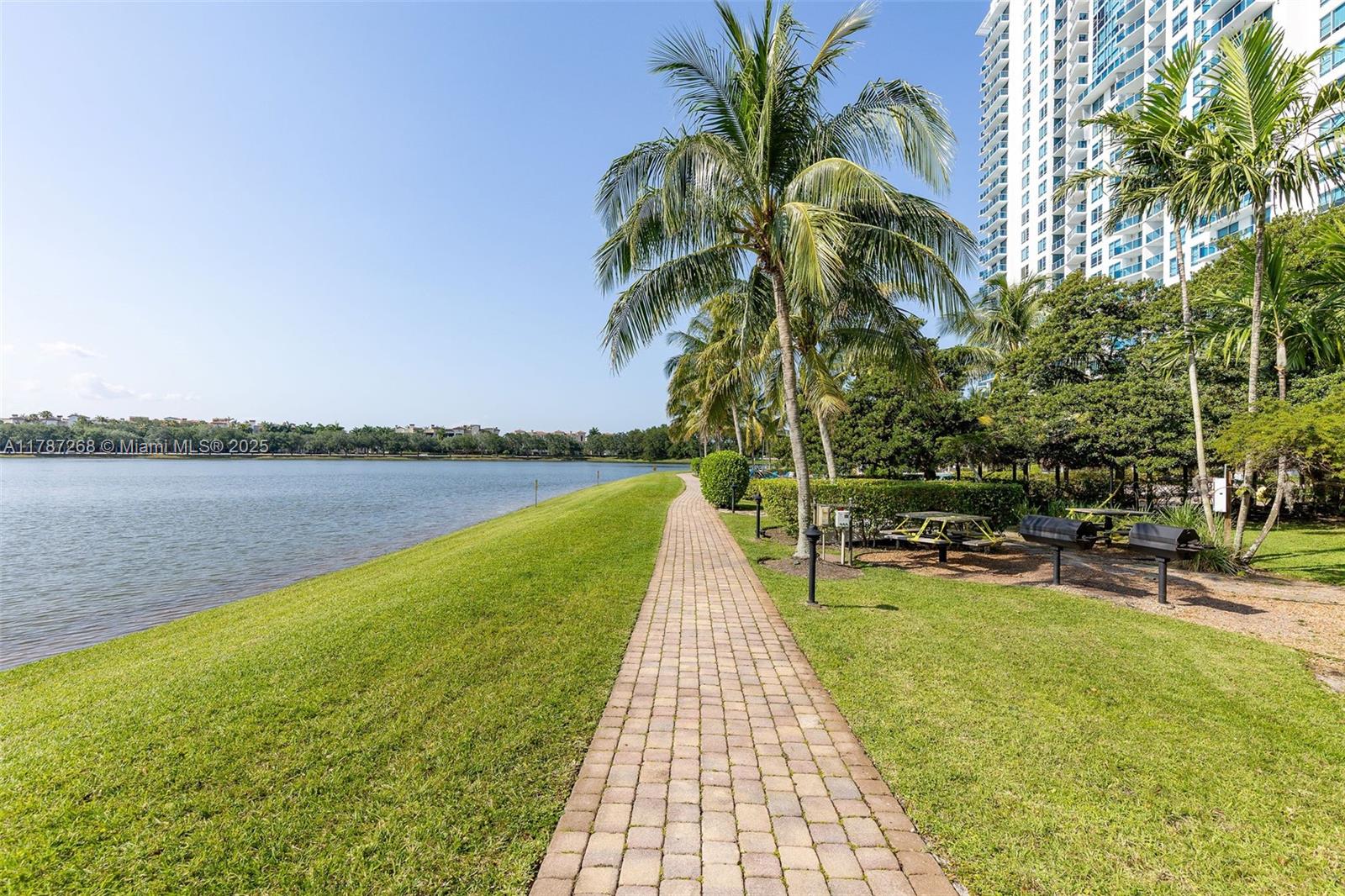 2681 North Flamingo Road, Unit TH4S Sunrise, FL 33323 - Photo 26 of 27 a view of a swimming pool with a lawn chairs and a lawn chairs