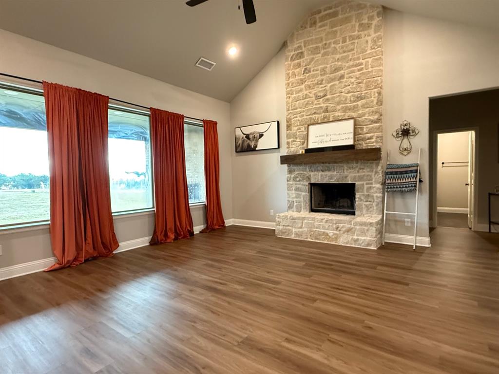 F1201 Sanger Drive Springtown, TX 76082 - Photo 2 of 11 Living room with a fireplace, dark wood finished floors, high vaulted ceiling, a ceiling fan, and recessed lighting