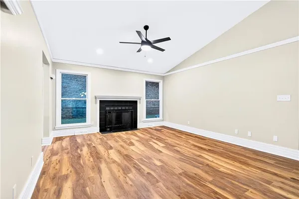 a view of empty room with window and fireplace