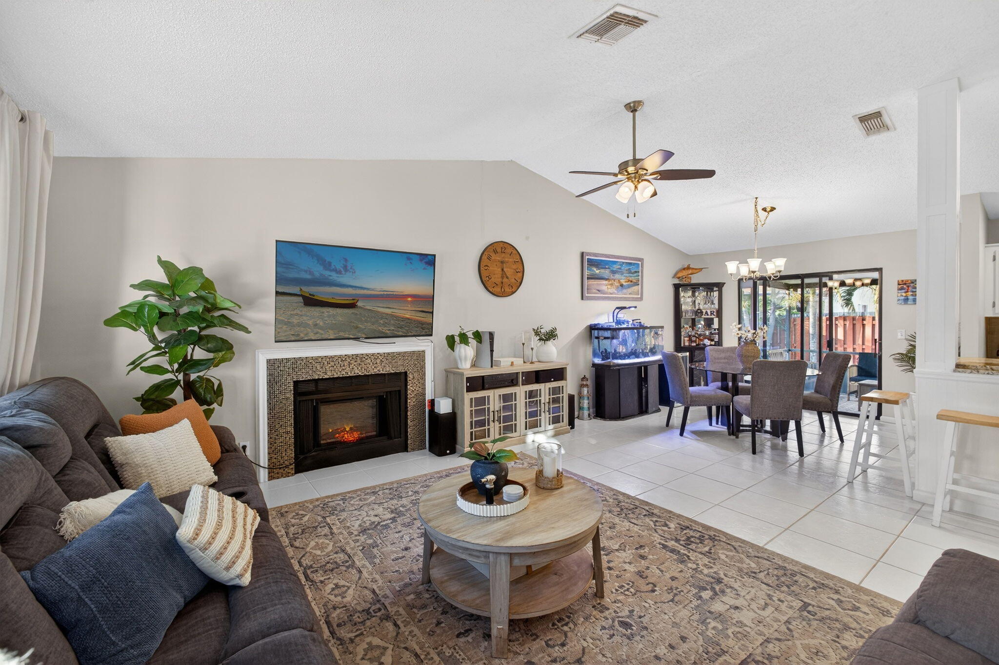 154 Rosewood Circle Jupiter, FL 33458 - Photo 11 of 43 a living room with furniture a fireplace a rug and a window