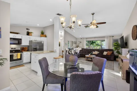 a kitchen with stainless steel appliances granite countertop a sink stove top oven and cabinets