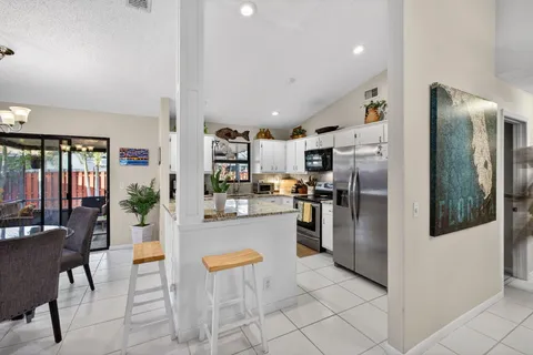 a kitchen with a table and chairs