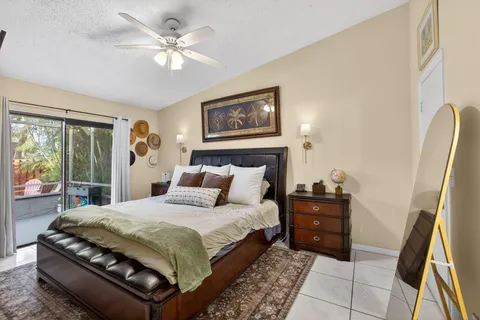 a bedroom with a large bed and a chandelier