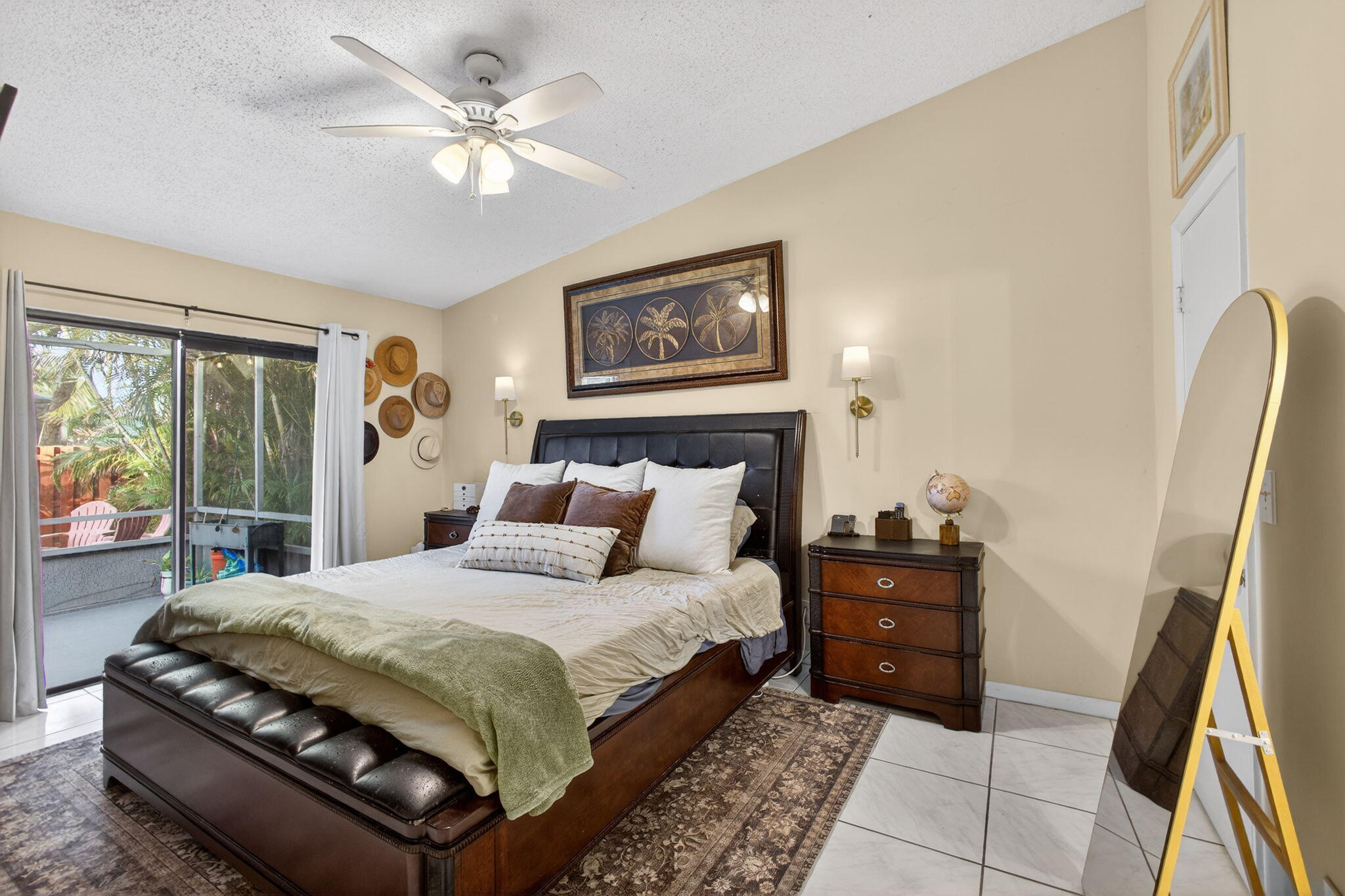 154 Rosewood Circle Jupiter, FL 33458 - Photo 20 of 43 a bedroom with a large bed and a chandelier