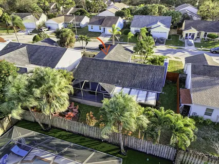 an aerial view of a house with garden space and street view